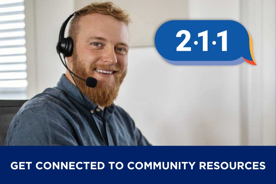 A bearded man with a headset on to take calls, along with the 2-1-1 logo and the text Get Connected to Community Resources
