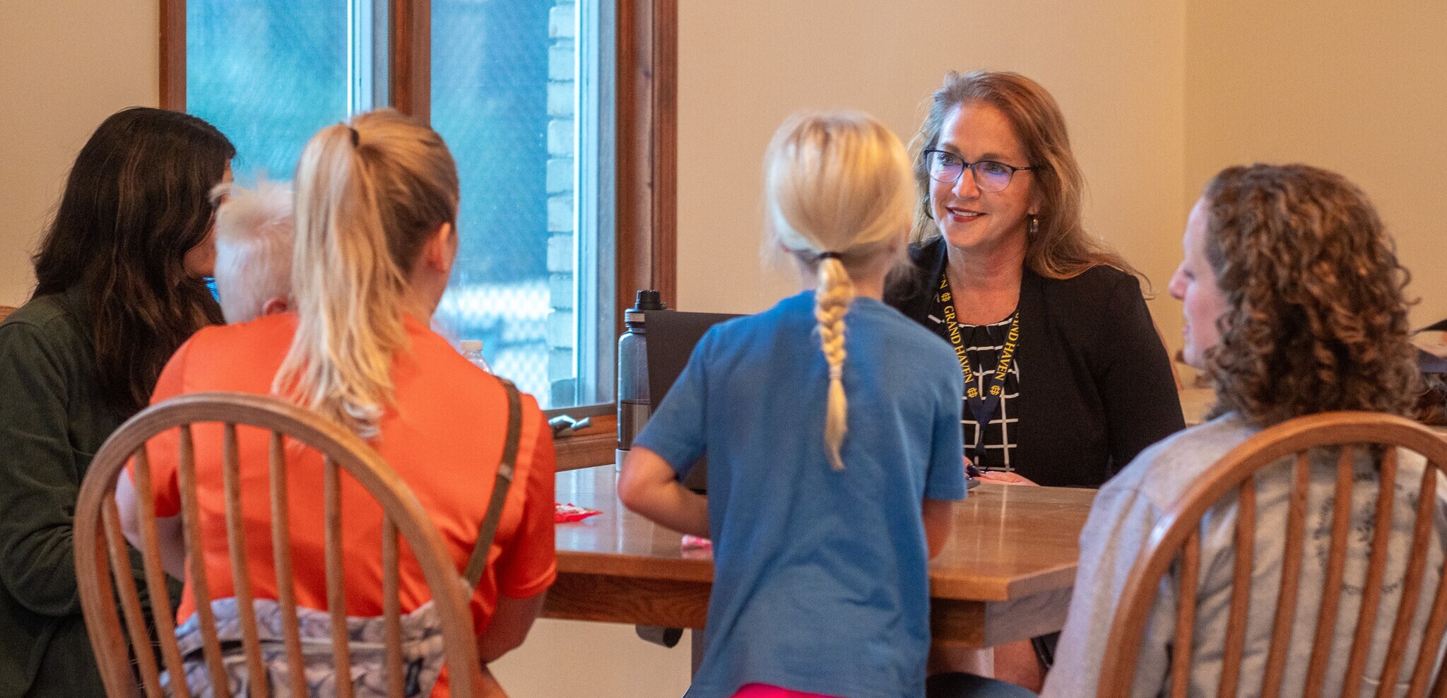 Superintendent Perkowski meeting with a group of families at a table.