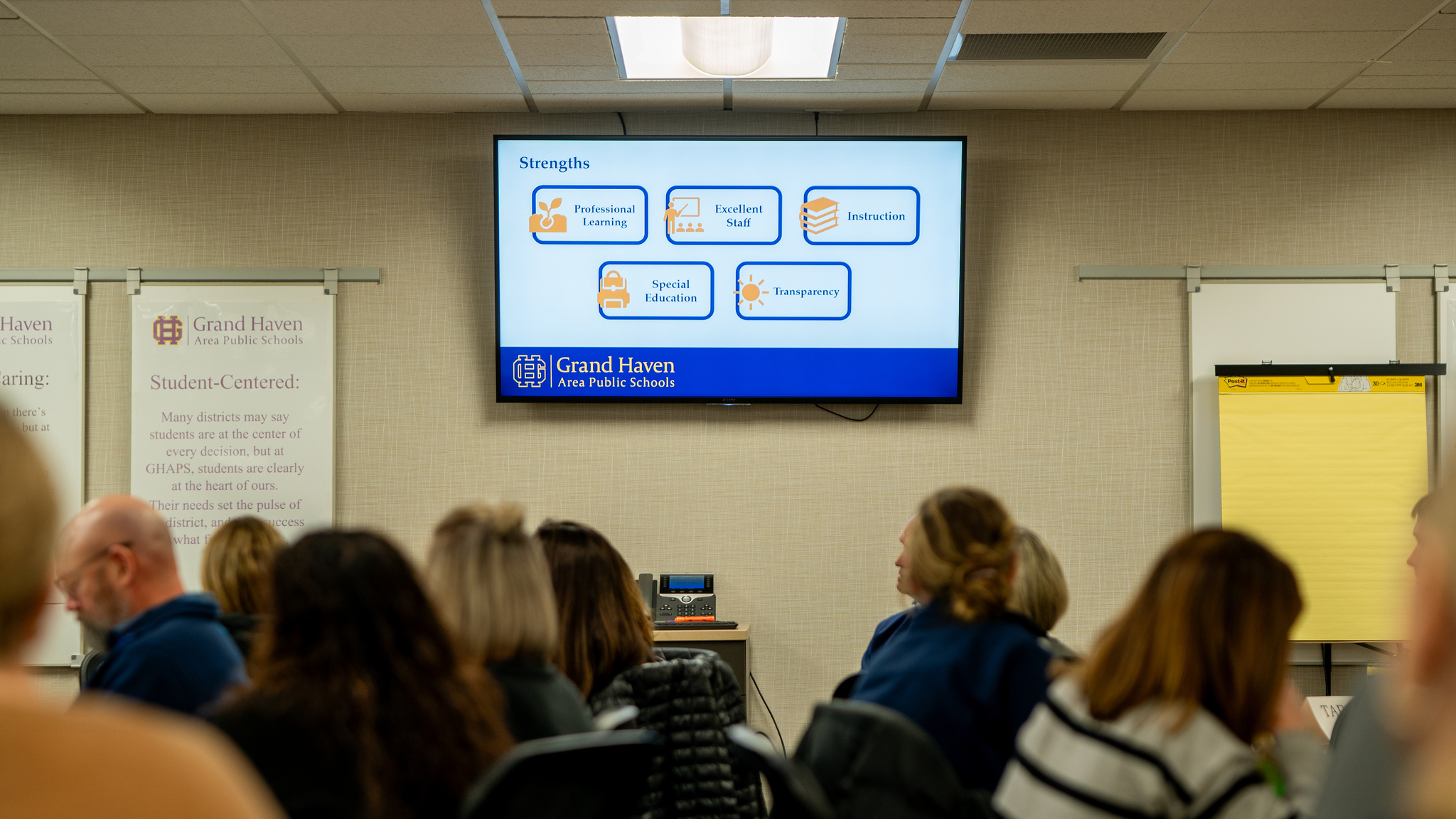 Strategic Plan Working Group viewing a presentations that lists the strengths of GHAPS: Professional Learning, Excellent Staff, Instruction, Special Education, Transparency